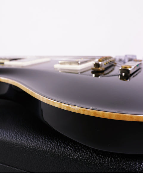 Close-up shot of a black PRS McCarty 594 electric guitar, emphasizing its stunning finish and design from 2016.
