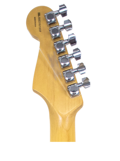 Close-up shot of a guitar head from a 2004 Fender American Deluxe Stratocaster with a white background.
