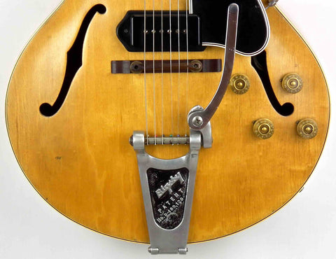 Close-up shot of a vintage Gibson ES 175 DN guitar from 1953, showcasing its metal strap.