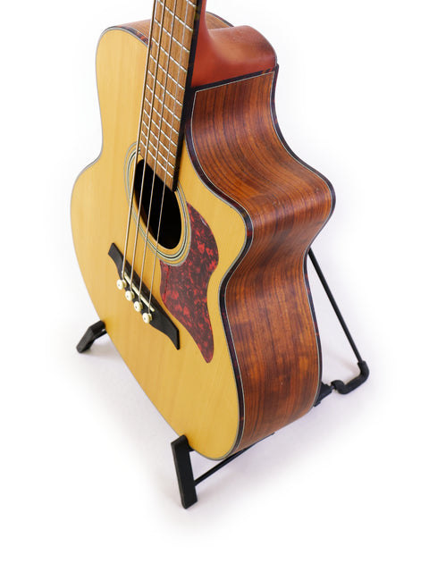 Compact Gilman GAB10CE acoustic guitar displayed on a stand, ideal for aspiring musicians and music lovers alike.
