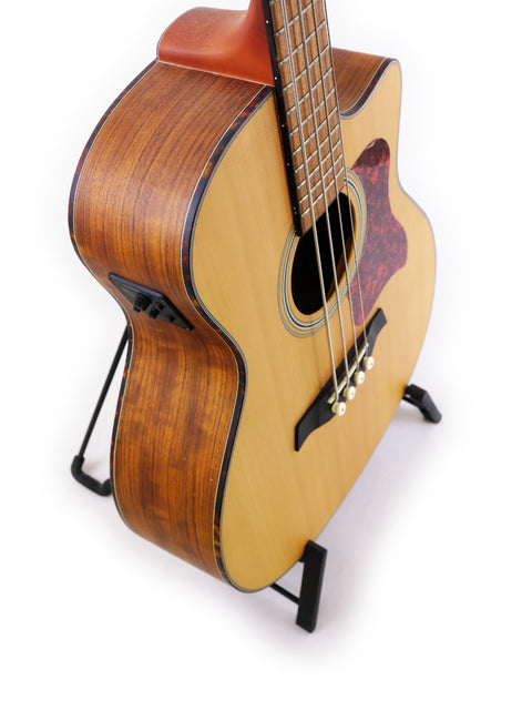 Compact Gilman GAB10CE acoustic guitar on a stand, designed for easy playability and rich sound for music lovers.