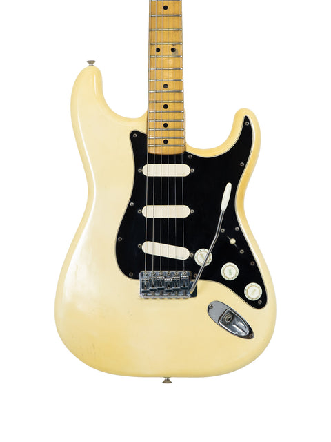 Cream-colored Fender Custom Shop Stratocaster, a vintage 1976 USA model, representing timeless guitar artistry.