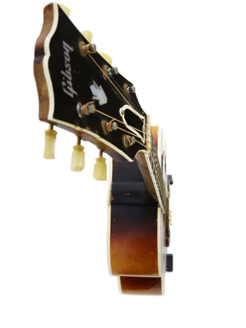 Detailed view of a 1954 Gibson J-200 guitar headstock, highlighting its vintage features and elegant finish.