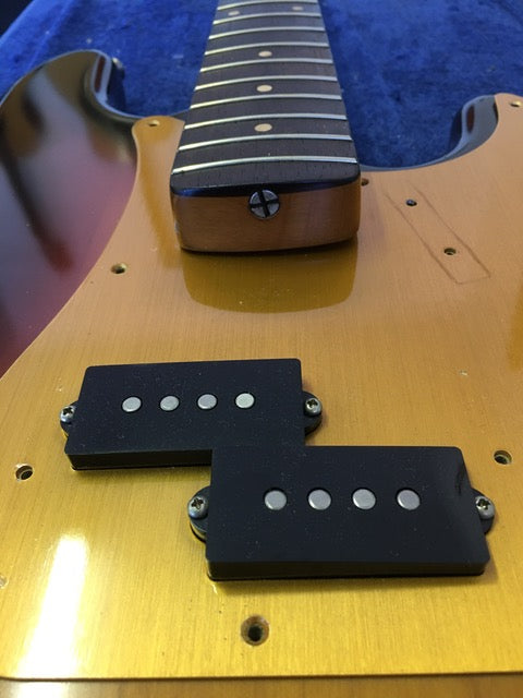 Detailed view of a 1958/59 Fender Precision Bass, highlighting its two pickups and classic design.