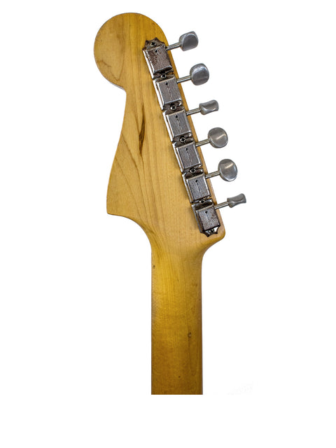 Detailed view of a 1960 vintage Fender Jazzmaster guitar head, highlighting the wooden body and classic craftsmanship.