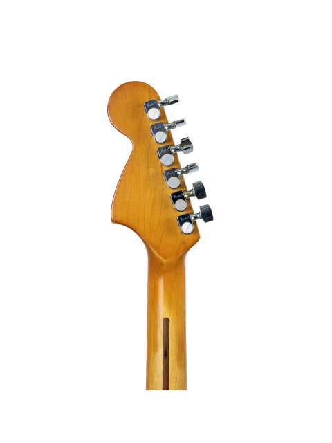 Detailed view of a Fender Stratocaster guitar head featuring a wooden body and sleek black pickguard.