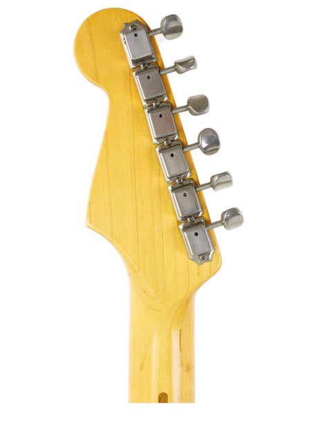 Detailed view of a Fender Vintage Hot Rod ‘57 Stratocaster neck, set on a bright white backdrop.