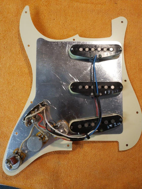 Detailed view of a Warmoth Strat Partscaster from 2012, highlighting a white pickguard and dual pickups for a classic look.