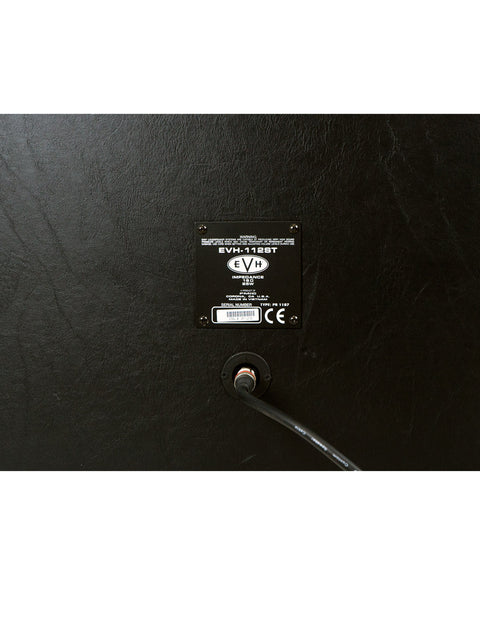 Detailed view of a black wall adorned with a black sticker, highlighting the EVH 5150 III 50 Watt Amp Head & Cab from 2014.