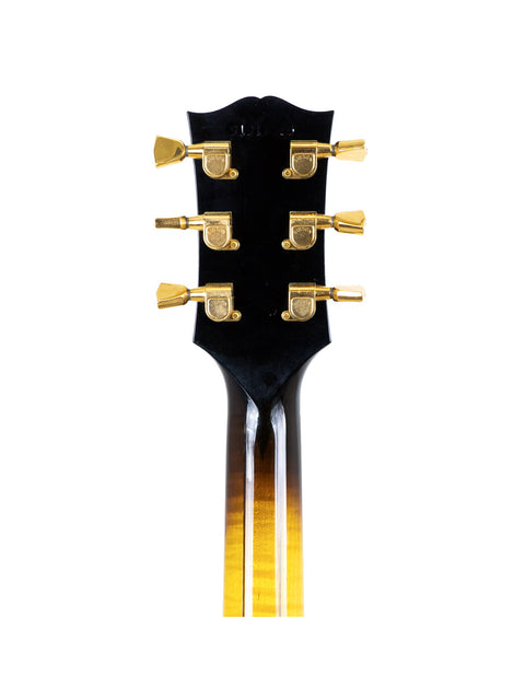 Detailed view of a guitar headstock with gold hardware, identified as Gibson Custom Shop Le Grand Archtop, USA 1997.