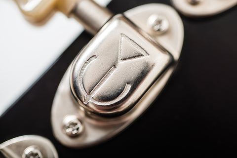Detailed view of a silver metal lock on a door, highlighting its sleek design and functionality.