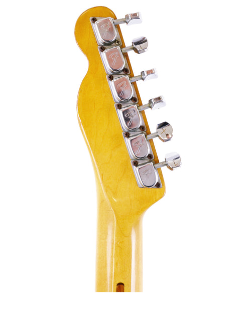 Detailed view of a yellow-bodied Fender Telecaster Custom guitar head, highlighting its vintage 1977 USA craftsmanship.