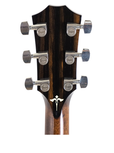 Detailed view of the black headstock of a 2016 Taylor 614ce acoustic guitar, emphasizing its quality and style.