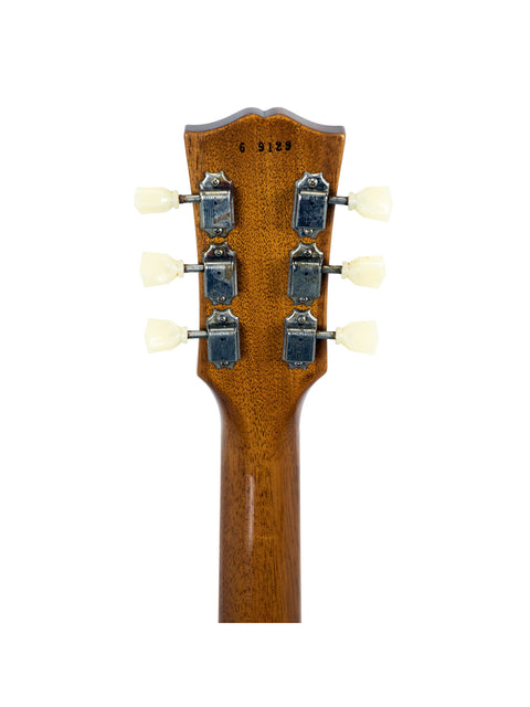 Detailed view of the headstock from a 2019 Gibson Les Paul Goldtop, featuring four knobs that enhance its vintage appeal.