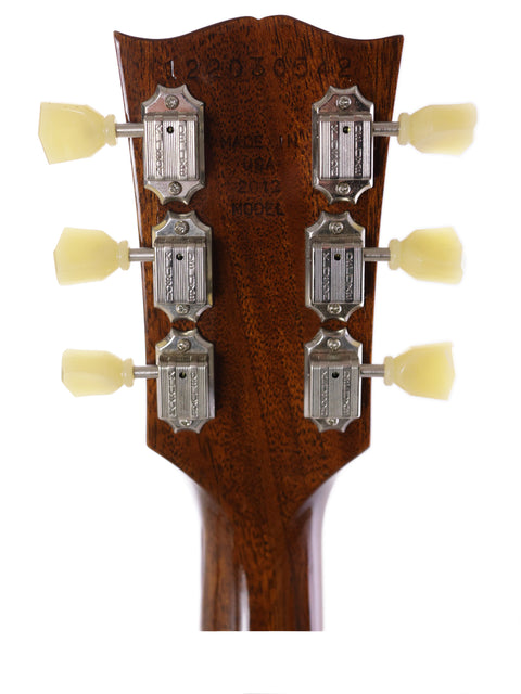 Detailed view of the headstock from a Gibson Les Paul Traditional acoustic guitar, featuring four distinct knobs for tuning.