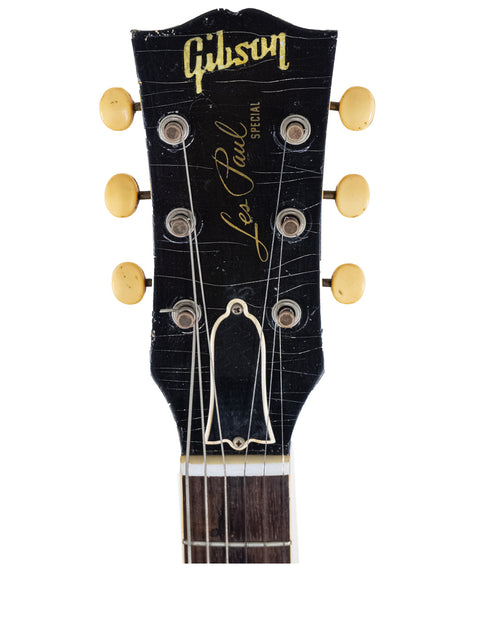 Detailed view of the headstock of a 1958 Gibson Les Paul Special Double Cut guitar, emphasizing its vintage refinished style.