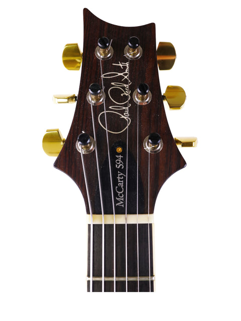 Detailed view of the headstock of a 2016 PRS McCarty 594 electric guitar, highlighting its unique features and finish.
