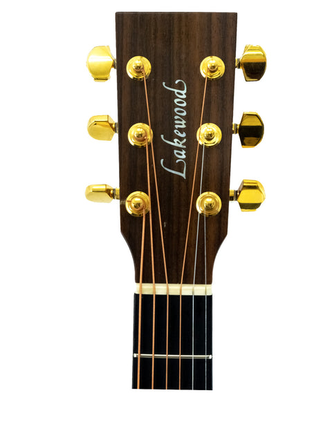 Detailed view of the headstock on a 2015 Lakewood D-32 Dreadnought acoustic guitar, highlighting its elegant features.