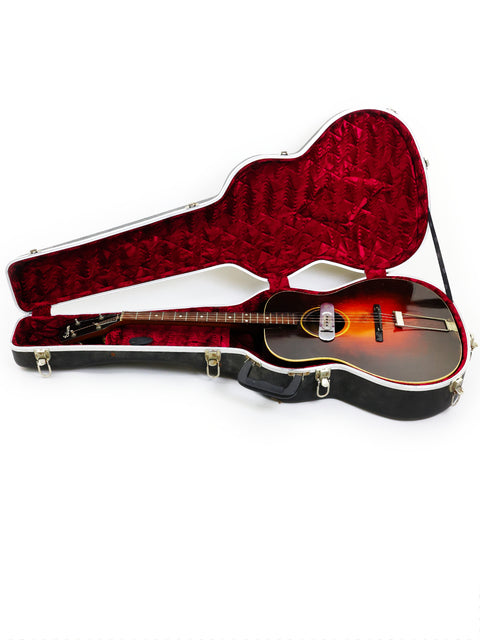 Discover the elegance of a 1934 Gibson TG50 Tenor Guitar nestled in a striking red and black case, ideal for collectors.