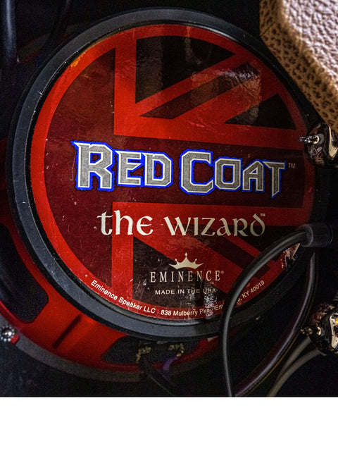 Displayed in a room, a red coat wizard drum kit is seen alongside a 2008 Carr Rambler Combo Amp.