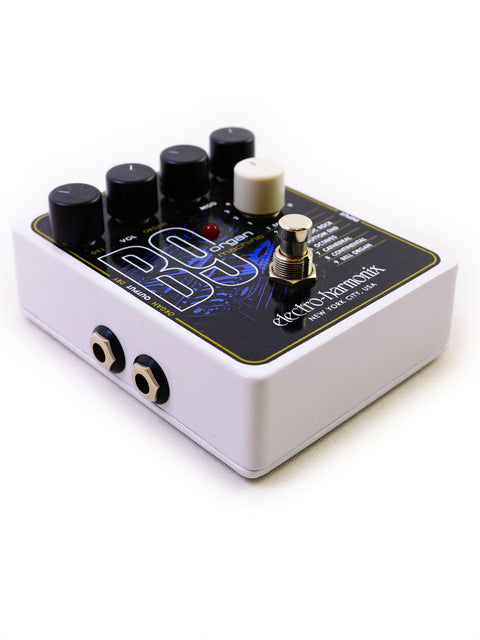 Electro Harmonix B9 pedal in white and black, equipped with four knobs for customizing audio effects.