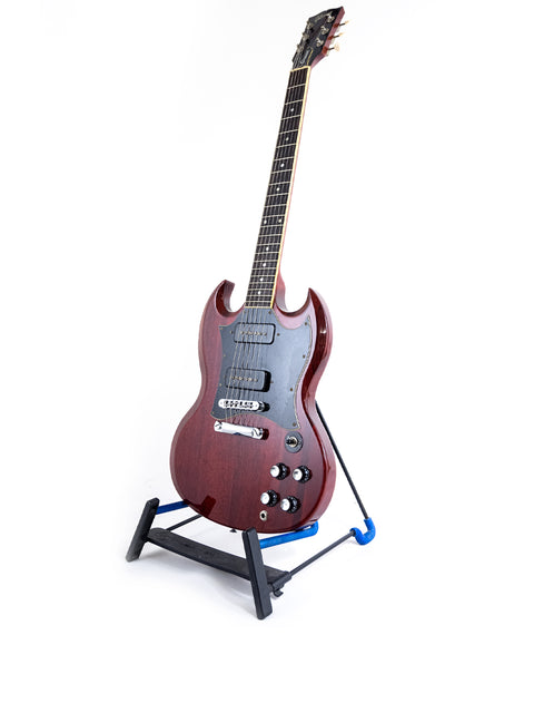 Elegant Gibson SG Classic guitar showcased on a blue base, perfect for adding a touch of class to your music setup.