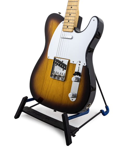 Fender American Vintage ’58 Telecaster guitar displayed on a stand with a stylish black base, highlighting its vintage appeal.