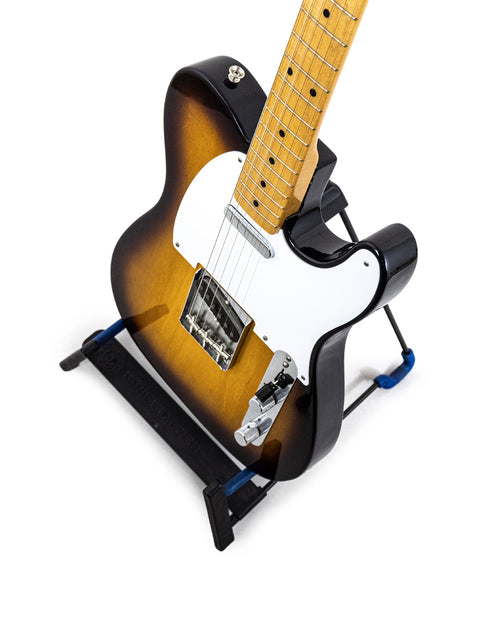 Fender American Vintage ’58 Telecaster guitar with a striking black pick guard and a classic white neck, highlighting its special edition.