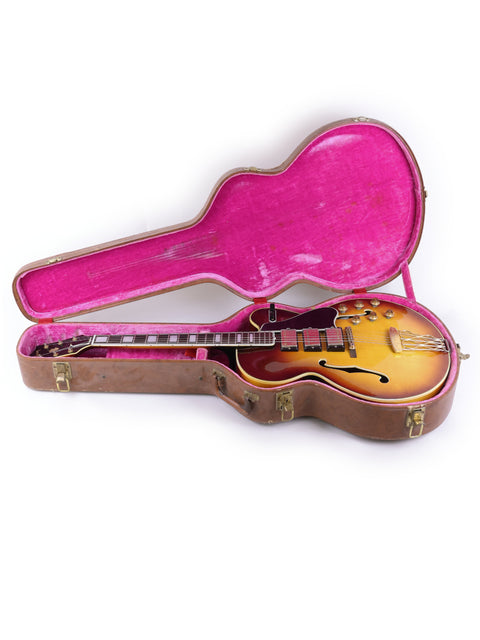 Gibson Les Paul Custom guitar, showcasing its classic design and craftsmanship, alongside a 1959 Gibson ES-5 Switchmaster.