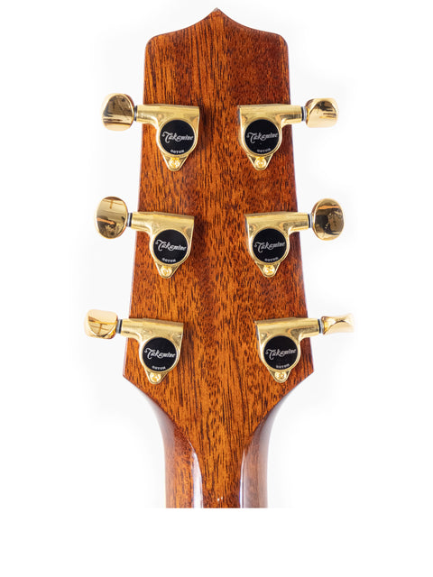 Headstock of a Takamine TSP138C TB acoustic guitar with striking gold hardware, representing Japanese artistry from 2020.
