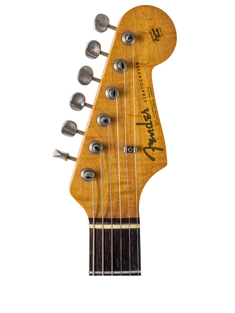 Headstock of a vintage 1964 Fender L Series Stratocaster in Fiesta Red, showcasing its classic design and craftsmanship.