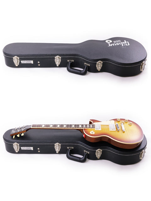 Image of two guitars in cases, highlighting a Gibson Les Paul Traditional, USA 2013, emphasizing craftsmanship and style.
