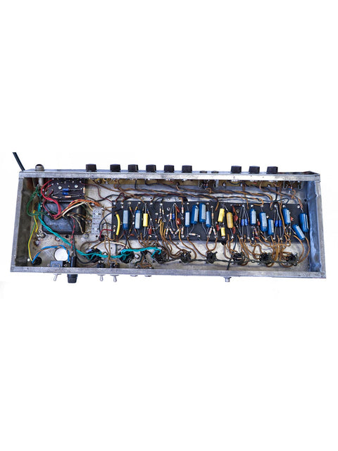Inside a 1961 Fender 6G12A Concert Amp, a metal box reveals a complex arrangement of wires and electronic components.