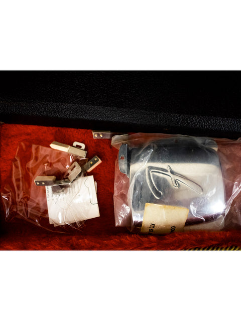 Inside a black case, two pairs of scissors are displayed alongside the Fender Custom Shop ‘62 Jazz Bass Reissue from 2001.