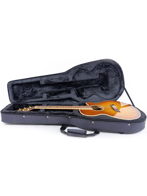 Inside a guitar case, a Takamine TSP138C TB Thinline Acoustic Electric guitar rests, ready for performance or travel.