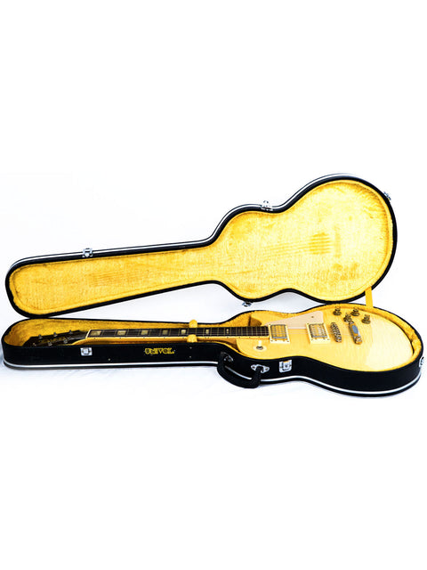 Inside a guitar case, a vibrant yellow Univox Gimmie U-1988 guitar from Japan, produced between 1974 and 1975, is displayed.
