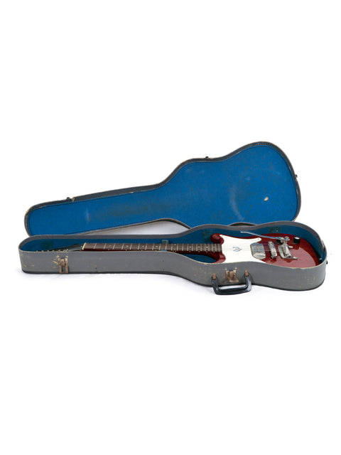 Isolated on white, a red Fender electric guitar, Epiphone Coronet 1965, alongside its protective case.