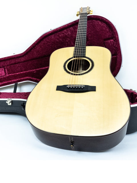 Lakewood D-32 Dreadnought guitar in a case, displayed against a clean white background, highlighting its craftsmanship.