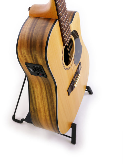 Maton EM425C 12-string guitar resting on a stand, with a simple white backdrop that accentuates its features.