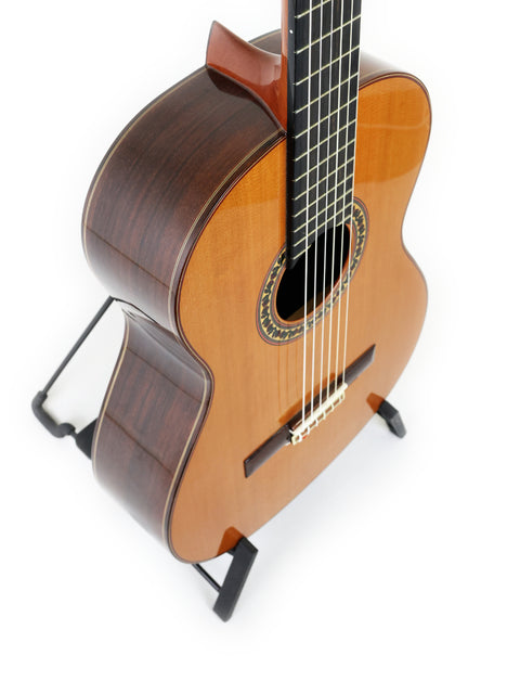 Ramirez 4NE guitar, Spain 2012, elegantly positioned on a stand with a simple white backdrop.