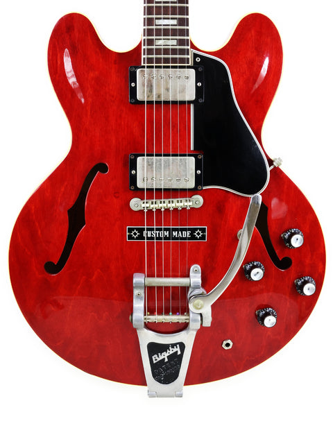 Red vintage Gibson ES-335 guitar from 1963, equipped with a black pickup, perfect for collectors and musicians alike.