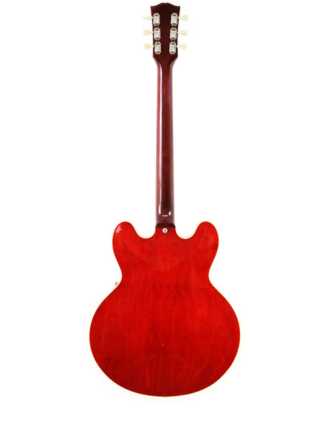 Red vintage Gibson ES-335 guitar from 1963 on a plain white background.