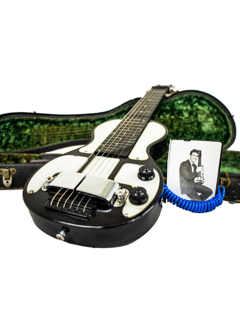 Rickenbacher Electro Lap Steel guitar in black and white, displaying a man's photo, highlighting 1930s American style.