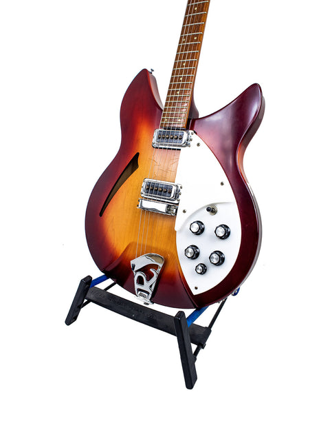 Rickenbacker 330 guitar, Fireglo model from 1994, showcased on a stand with a plain white background.