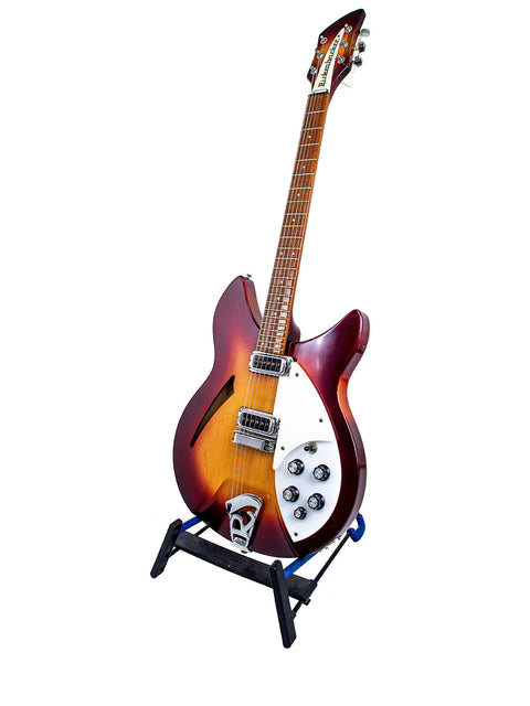 Rickenbacker 330 guitar in Fireglo color on a stand, set against a clean white backdrop.