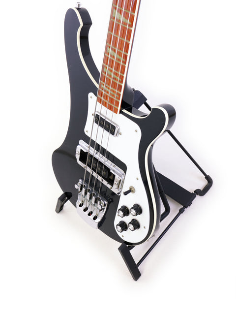 Rickenbacker 4003 Jetglo Bass in black and white, resting on a stand, emphasizing its classic style and quality.