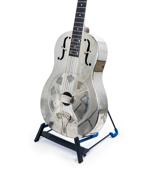 Silver guitar on a stand, featuring the National Resophonic Style N Resonator, set against a blue backdrop.