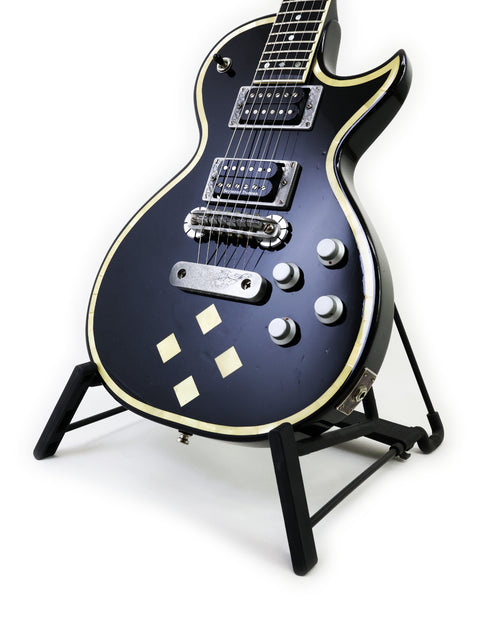 Sleek black Greco Zemaitis GZ-2600IF electric guitar on a stand, ideal for serious players looking to enhance their sound.