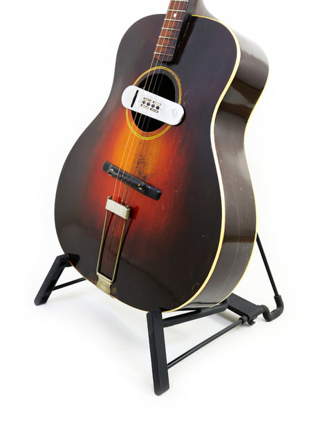 Stunning 1934 Gibson TG50 Tenor Guitar showcased on a stand, ideal for adding charm to any music collection.