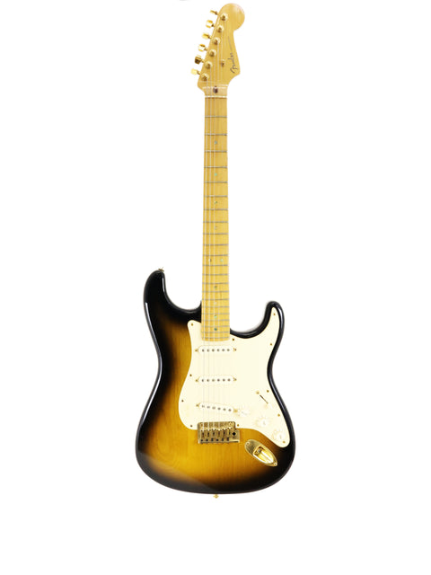 Sunburst electric guitar with maple neck on a white background.